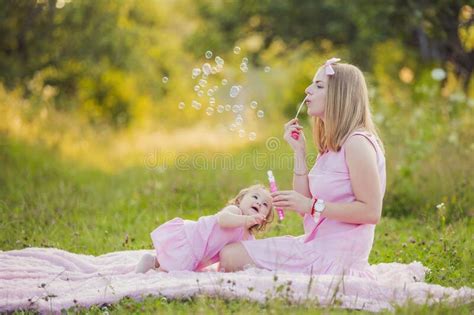 mother and daughter blowing bubbles stock image image of blow