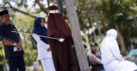 indonesian woman is caned in public for having sex outside marriage