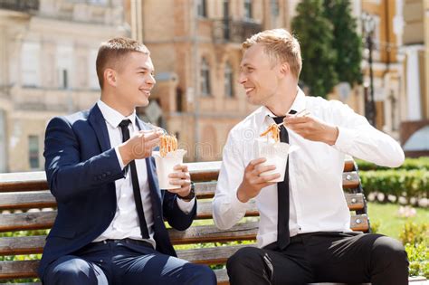 two handsome men eating chinese noodles stock image