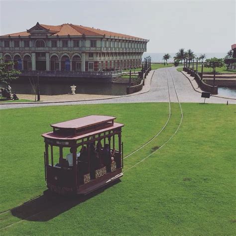 trolley car   grass   building