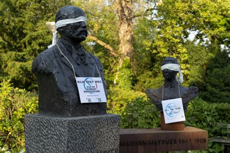 climate activists blindfold delft statues delta