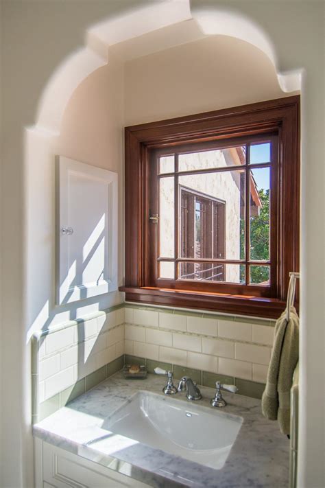traditional white bath  marble topped sink  spanish colonial window details hgtv