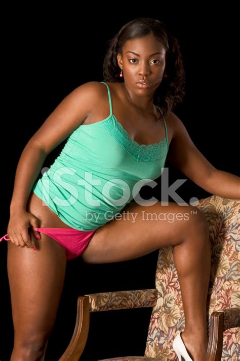 Sexy African American Woman In Lingerie By Chair Stock