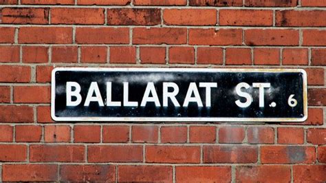black  white street sign mounted   brick wall   word ballard st