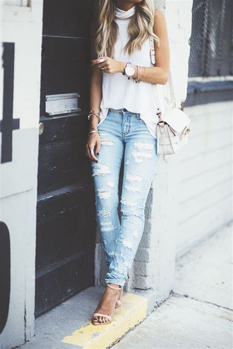 white tank top light wash ripped blue jeans heels