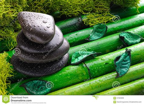 Stack Of Black Stones For Massage On Bamboo Top View Stock Image