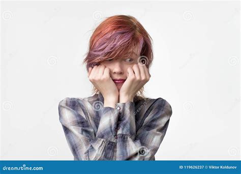 Indoor Portrait Of Shy Pretty Female Looking Embarrassed Wanting To Say