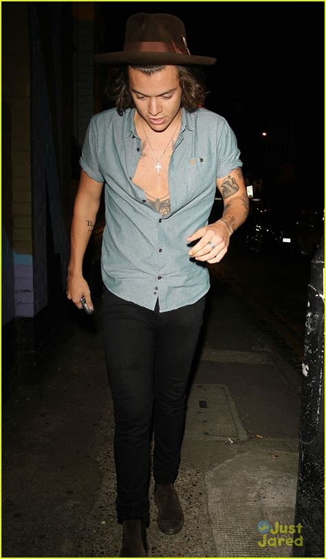 harry styles shows some skin in partially unbuttoned shirt