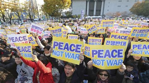oppose war negotiate peace thousands  south koreans protest    president donald