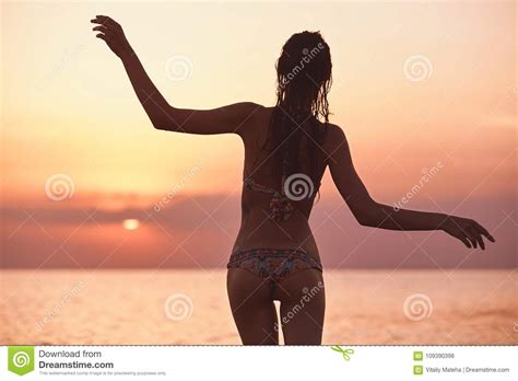 Silhouette Of A Beautiful Sexual Girl Against The Sea And Sunset Stock