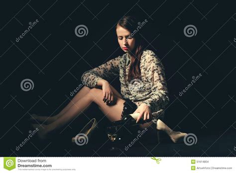 Beautiful Young Brunette Woman Holding A Bottle Of White Wine Stock