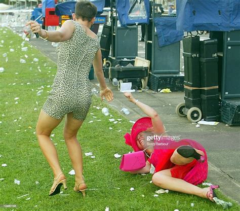 two drunk race goers make their way home after the last race of the