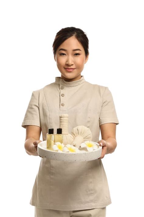 Professional Masseuse In Uniform Holding Tray With Spa Supplies Stock