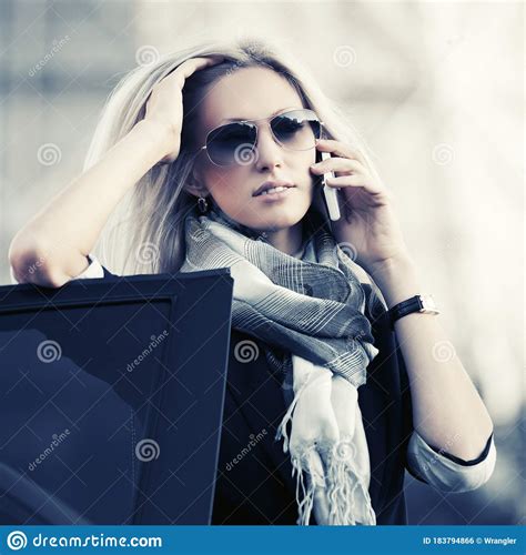 Fashion Business Woman In Sunglasses Talking On Cell Phone Leaning On