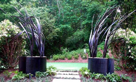 hand  steel garden sculpture leaves  grass