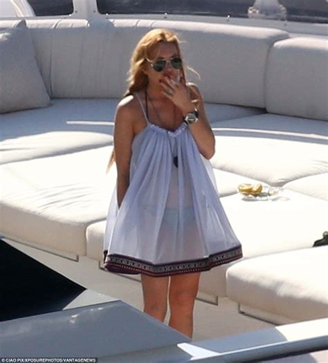 lindsay lohan shows pregnant stomach in bathing suit as she smokes a cigarette daily mail online