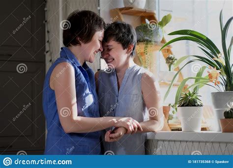 Same Sex Female Couple Taking A Selfie In Their Home Stock