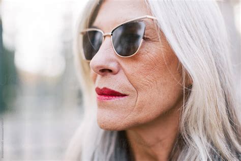 Closeup Portrait Of A Mature Woman With Grey Hair Wearing Sunglasses