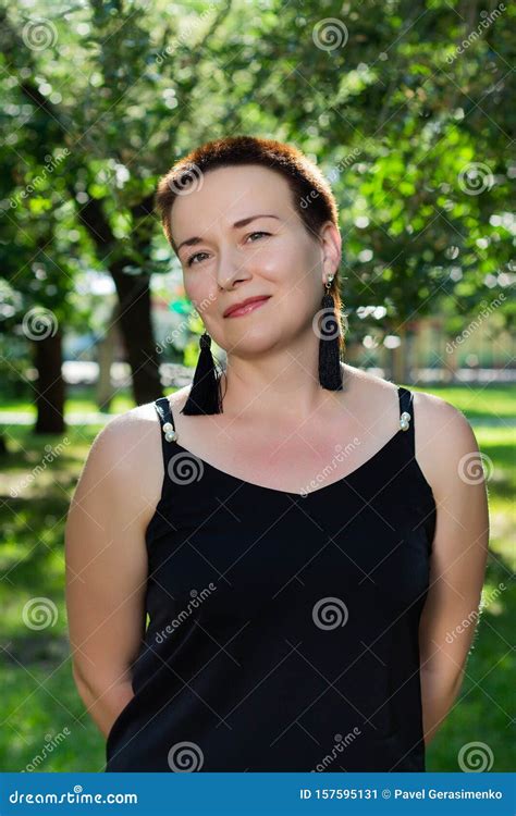 Close Up Portrait Of A Beautiful Short Haired Woman In The Park Stock