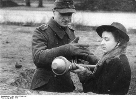 [photo] A German Volkssturm Soldier Teaching A Woman How To Operate The