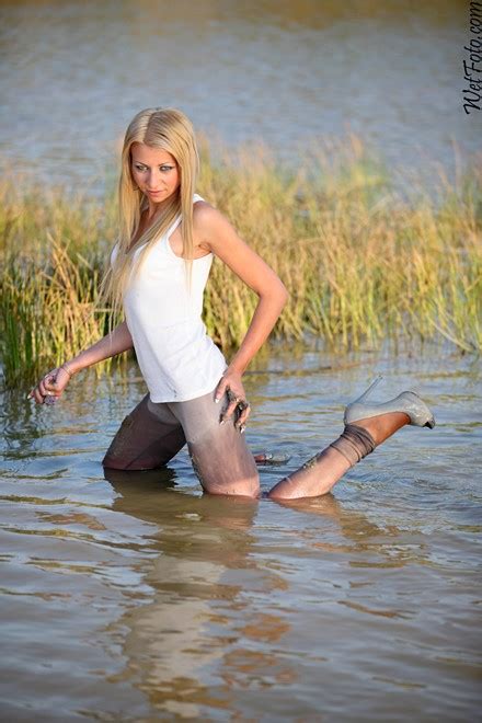 crazy wetlook by hot blond in jacket leggings and high heels on lake