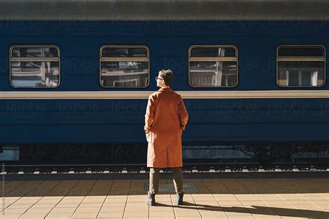 anonymous woman standing on train station by stocksy contributor