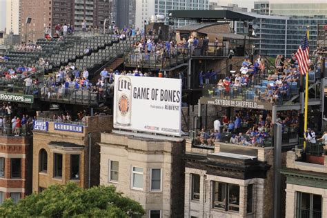 wrigley rooftops claim revenue   risk  cubs video boards bleed cubbie blue