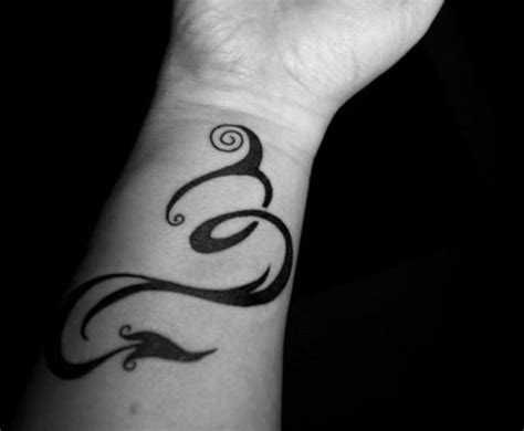 elegant zodiac sign wrist tattoos