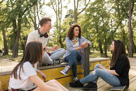 teenagers talking in the park by dejan ristovski