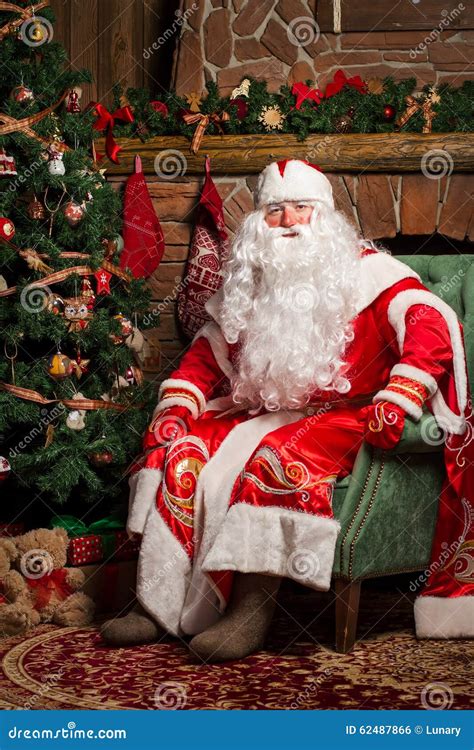 cheerful santa claus sitting   chair stock photo image