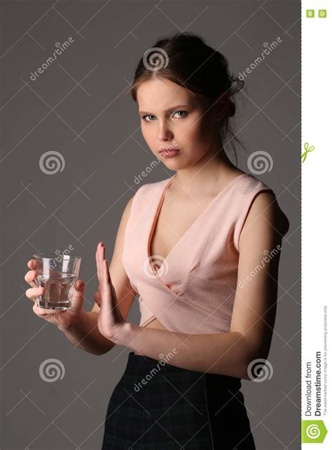 Teen Model In Pink Top Posing With Glass Of Water Close