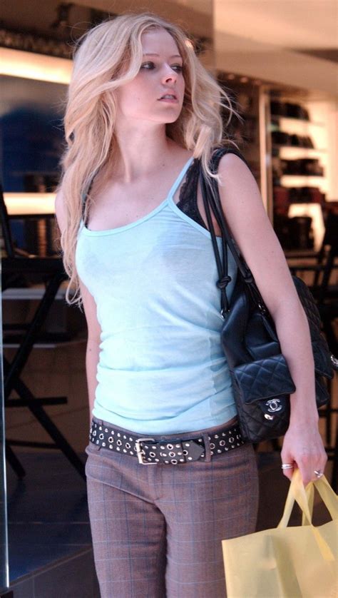 A Blonde Woman Carrying Shopping Bags In Her Hand