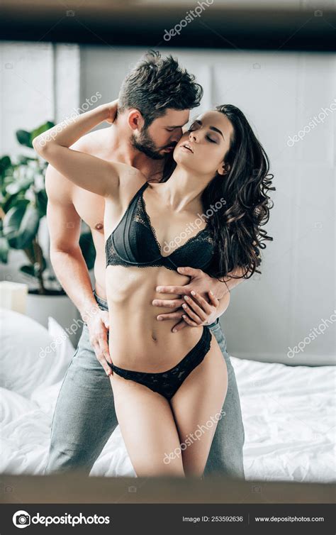shirtless man kissing sexy woman lace underwear while