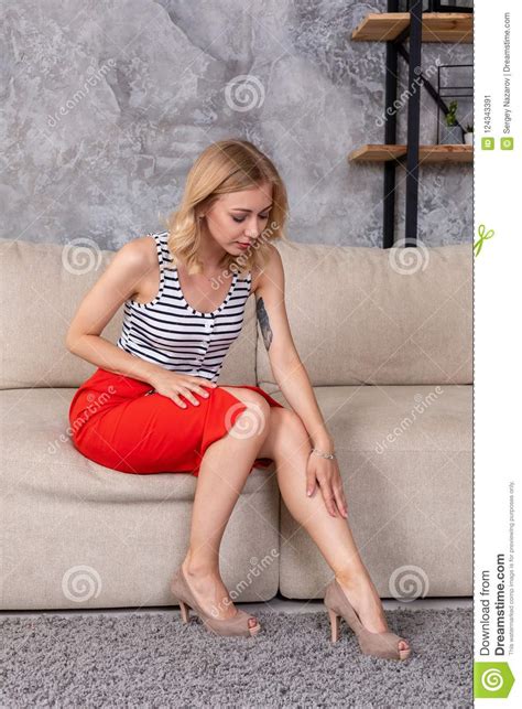 Woman In Fashionable Short Dress Skirt High Heels Sitting