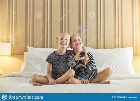 cute little brother and sister watching television on a