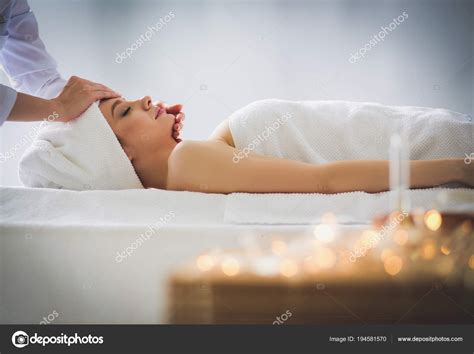 Young Woman Lying On A Massage Table Relaxing With Eyes Closed Woman