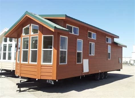 tiny house sitting      flatbed truck   parking lot