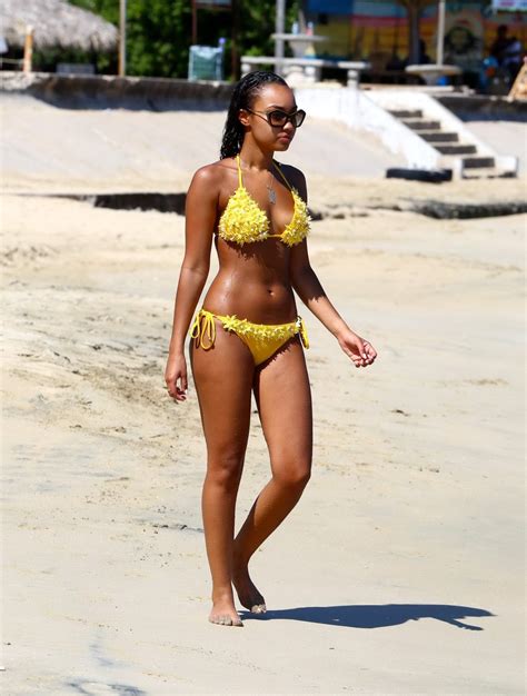 leighanne pinnock showing booty in yellow bikini on a jamaican beach