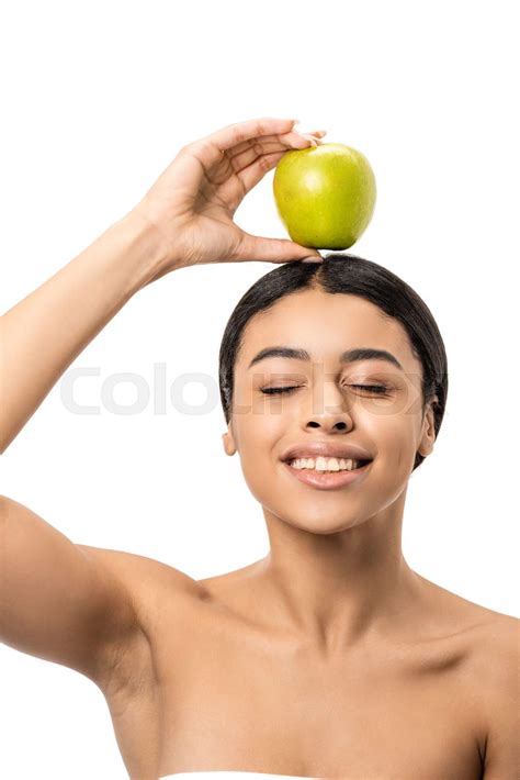 happy naked african american girl with closed eyes holding green apple