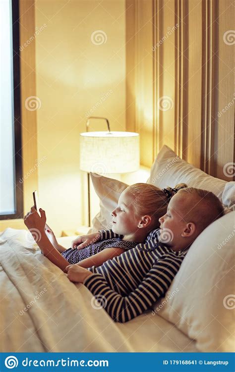 cute little brother and sister watching videos before bed