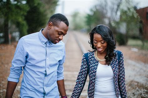 trendy and stylish african american couple holding hands while walking