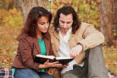 married couple reading bible    park  autumnedmonton
