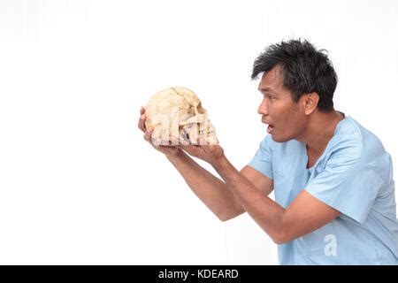 man holding  skull stock photo alamy
