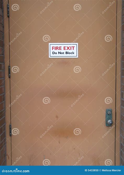 fire exit sign stock photo image  brown door building