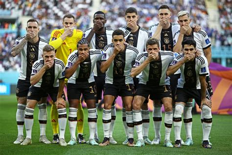 germany players covered  mouths  world cup team photo
