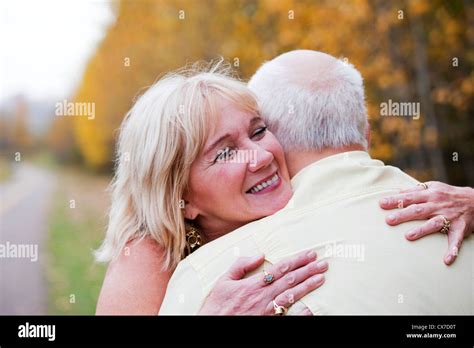 Mature Married Couple Enjoying Spending Time Together In Park During Fall Season Edmonton