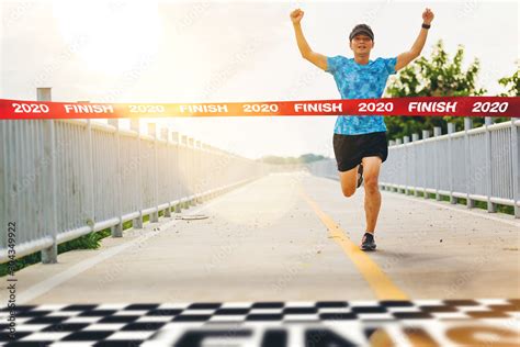 excited man runner crossing   finish   marathon