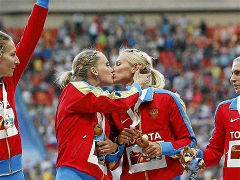 female russian runners kiss on winners podium to protest anti gay law