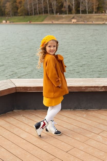 Premium Photo A Beautiful Blonde Girl In A Beige Coat In A Yellow