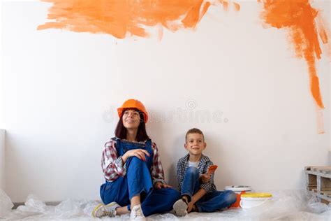 reparatie van appartementen moeder en zoon schilderden de binnenmuur met designer verf oranje